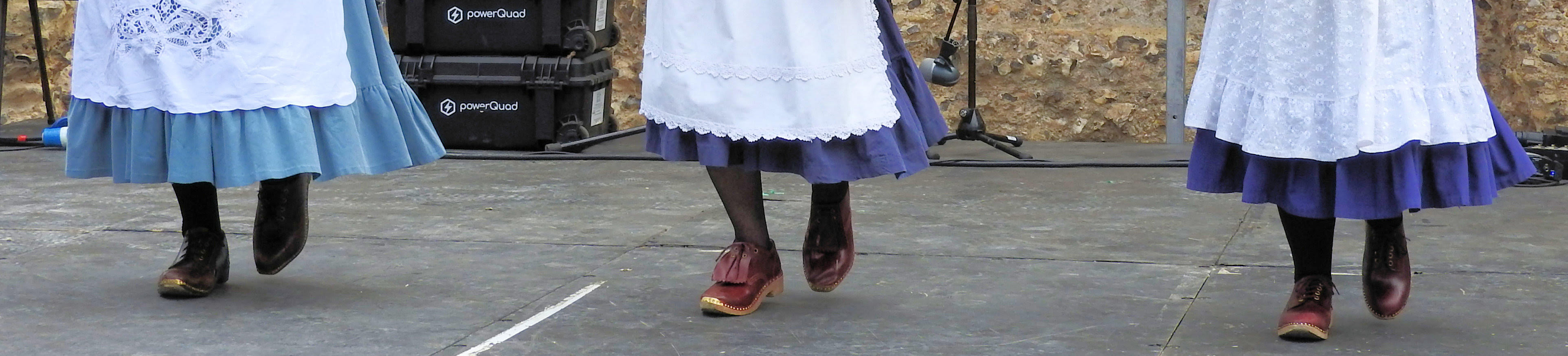 An image of some of Aldbrickham Clog's dancers. Three dancers' feet are shown wearing wooden-soled clogs.